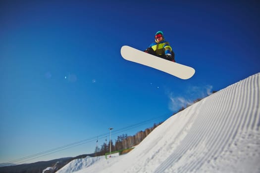 Sportsman practicing snowboarding at winter resort