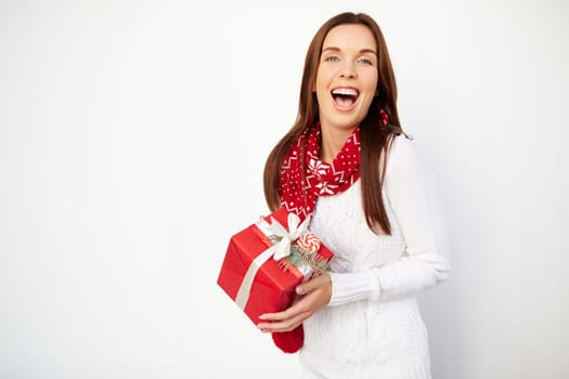 Ecstatic girl with Christmas gift looking at camera