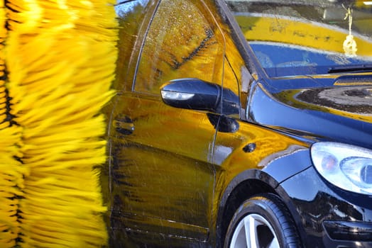 Car going through an automated car wash machine.