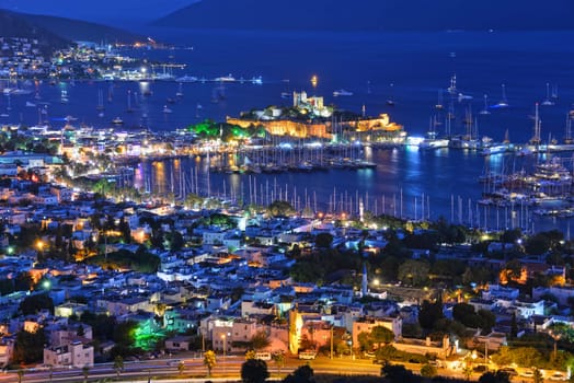 View of Bodrum harbor and Castle of St. Peter by night. Turkish Riviera.