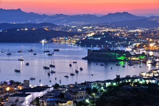 View of Bodrum harbor and Castle of St. Peter by night. Turkish Riviera.