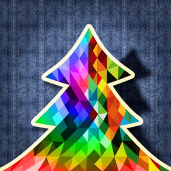 Trendy geometric Christmas tree made with colorful vintage hipster triangles over jean fabric background.