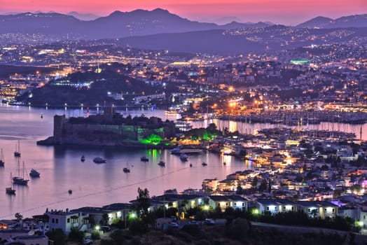 View of Bodrum harbor and Castle of St. Peter by night. Turkish Riviera.