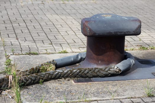 Weathered rope around a mooring in the port of Warnemünde