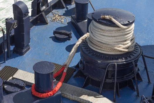 Winch,rope and bollard on deck of a large ship