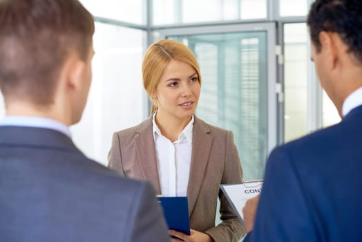 Serious businesswoman looking at her colleague during conversation