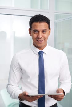 Happy businessman with touchpad looking at camera
