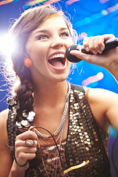 Ecstatic young woman singing karaoke
