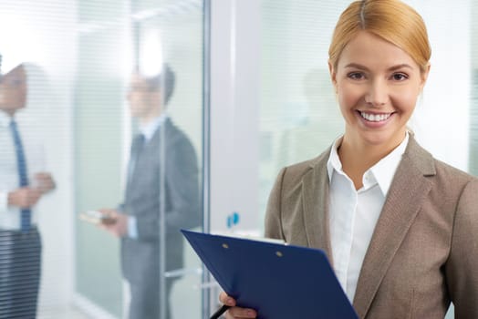 Successful employee in formalwear looking at camera in office