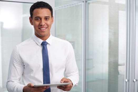 Young businessman with touchpad looking at camera with smile