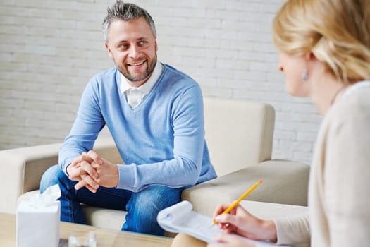 Happy patient talking to psychologist