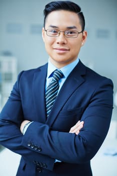 Successful Asian businessman in formalwear looking at camera