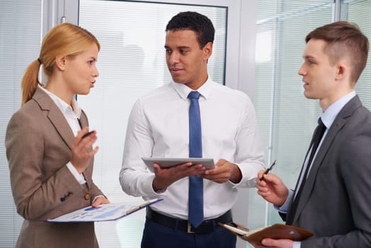 Serious colleagues discussing their plans and ideas in office