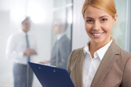 Pretty businesswoman looking at camera with smile