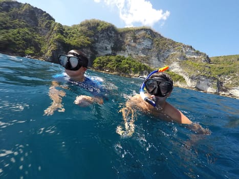 shoot of a young boy snorkeling with father
