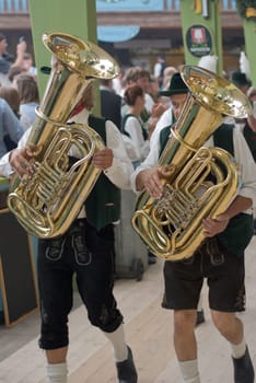 MUNICH, GERMANY – SEPT. 20, 2015: Traditional Marching Bands with Local Costumes entertain Crowds of visitors at the annual Oktoberfest. The Festival runs from September 19th until October 4th 2015 in Munich, Germany