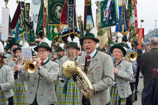 MUNICH, GERMANY – SEPT. 20, 2015: Traditional Marching Bands with Local Costumes entertain Crowds of visitors at the annual Oktoberfest. The Festival runs from September 19th until October 4th 2015 in Munich, Germany