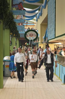 MUNICH, GERMANY – SEPT. 20, 2015: Traditional Marching Bands with Local Costumes entertain Crowds of visitors at the annual Oktoberfest. The Festival runs from September 19th until October 4th 2015 in Munich, Germany
