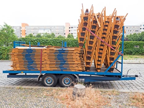 Trailer with benches and table tops parked on the side of the road