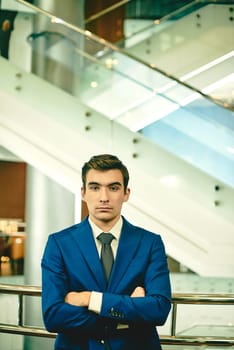 Serious businessman with crossed arms looking at camera