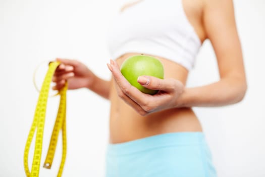 Slim female holding green apple