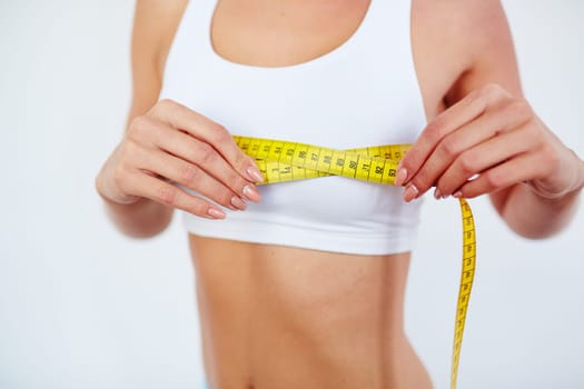 Young female measuring size of chest