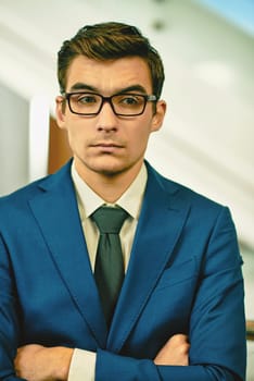 Serious businessman in formalwear and eyeglasses