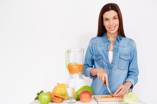 Pretty girl cutting ingredients for vegetable salad