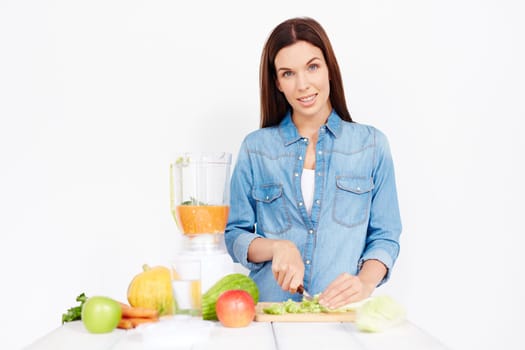 Pretty girl cutting vegetables for salad