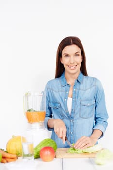 Healthy female cooking salad from vegetables