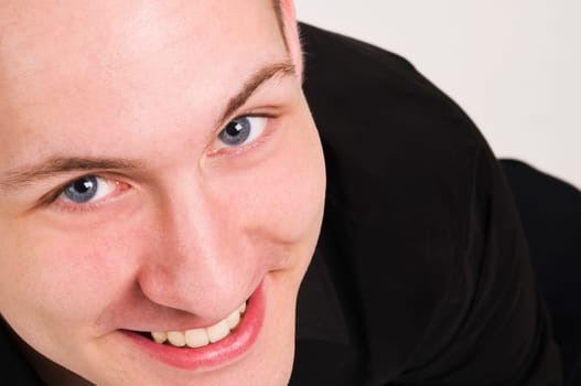 Closeup of a young man joyfully,looking up into the camera