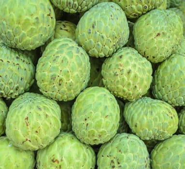 Stacks of ripe Custard apple or Sugar apple fruit in fresh market, Thailand