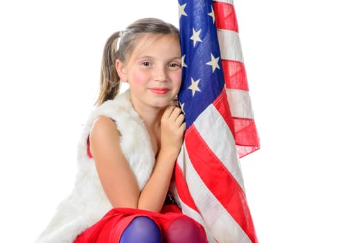 a pretty little girl sitting on a box with a american flag on the white background