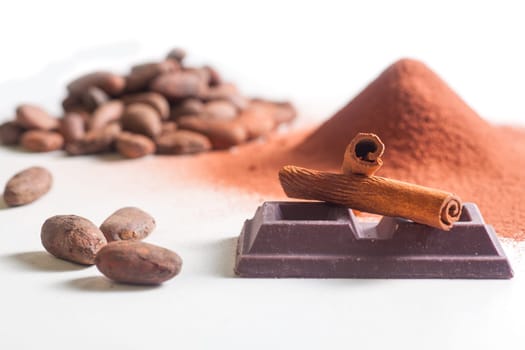Close up of chocolate bar, cacao and cinnamon