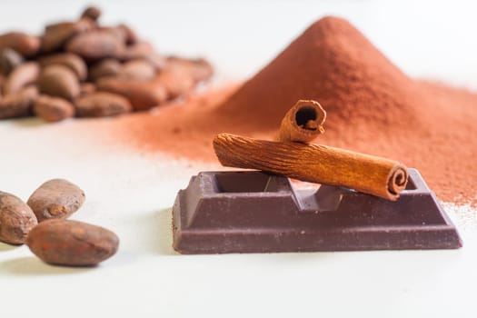 Close up of chocolate bar, cacao and cinnamon