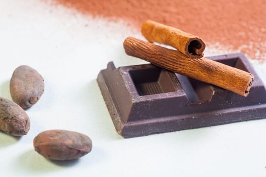 Close up of chocolate bar, cacao and cinnamon