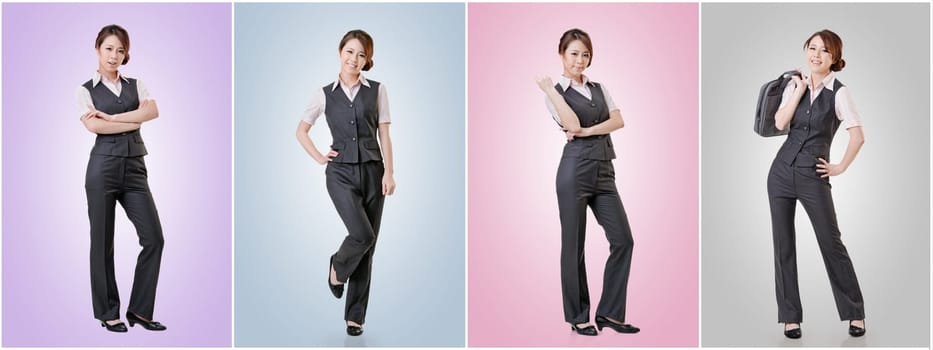 Asian business woman standing against studio background, full length portrait in a set.