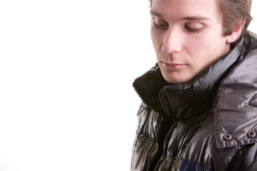 beautiful young man posing in winter with a warm anorak