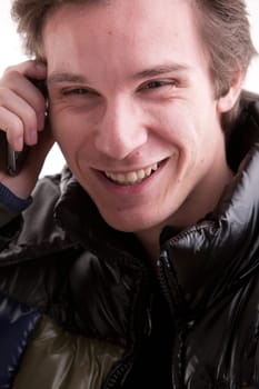 portrait oaf a goold looking young man phoning on a mobile phone