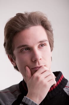 young good looking guy thinking about a new idea he had and about how can he make it reality