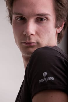 good looking young man looking intensely in camera like a fashion model does