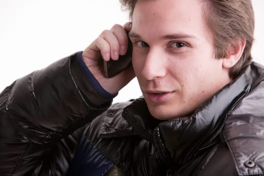 portrait oaf a goold looking young man phoning on a mobile phone