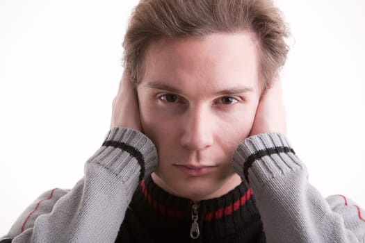 man covering ears with hands showing he can't ear