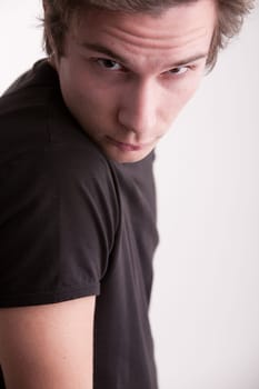 good looking young man looking intensely in camera like a fashion model does