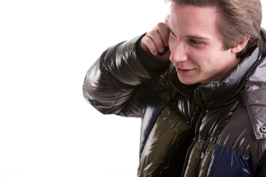 portrait oaf a goold looking young man phoning on a mobile phone