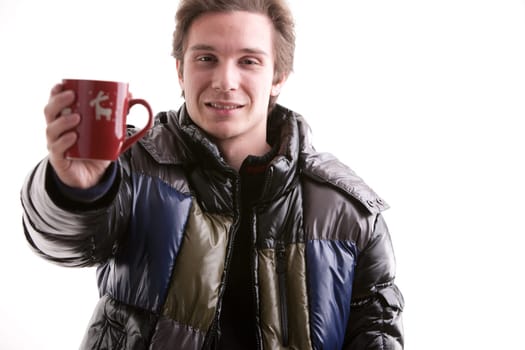 young man showing a red mug with christmas symbols