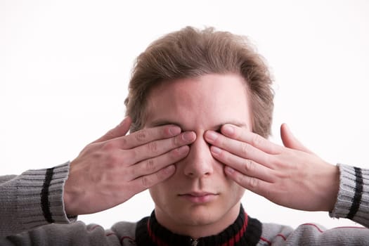 man covering his eyes with his hands showing he can't see (hands on eyes)
