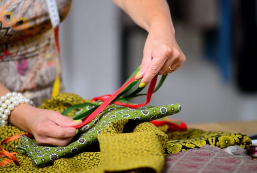 close up of the hands of a dressmaker