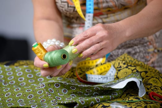 close up of the hands of a dressmaker