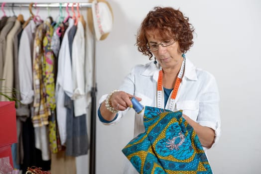 middle-aged dressmaker working in his workshop